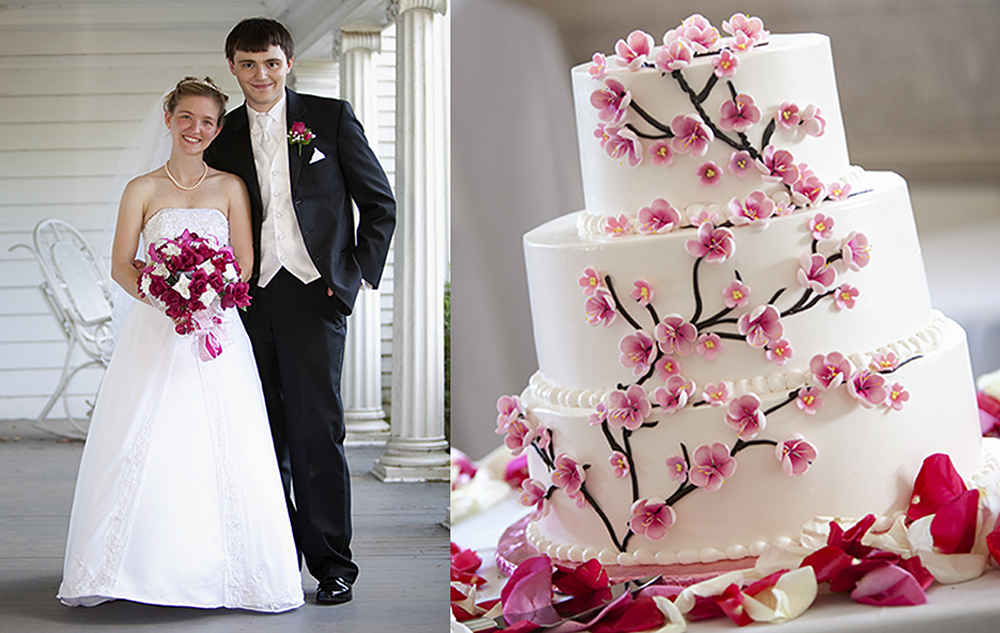A bride and groom stand on a porch, both smiling at the camera. The bride holds a bouquet, and the groom wears a black suit. Next to them is a three-tiered white wedding cake decorated with pink floral designs.