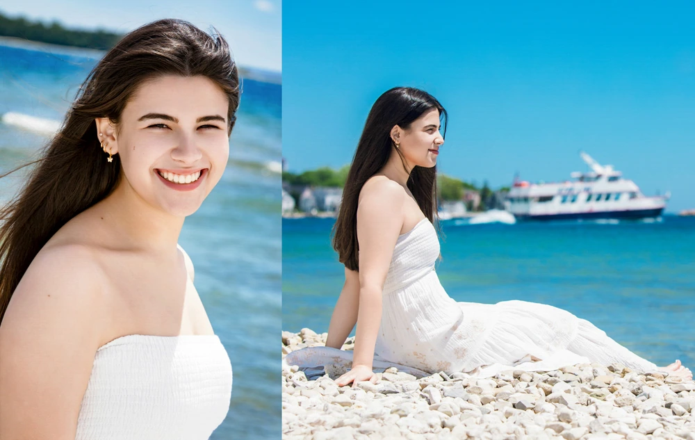 A high school senior girl in a white dress is pictured smiling near the water, capturing timeless Mackinac Island senior pictures. On the left, she stands with a wide smile; on the right, she sits on white pebbles gazing at a boat and distant shore.