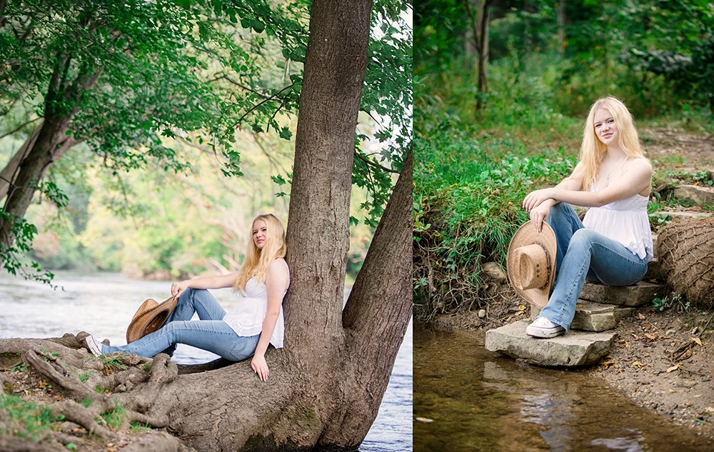 A high school senior girl with long blonde hair, wearing a white top and blue jeans, enjoys her Nichols Arboretum senior pictures session by the river—sitting on a tree in one photo and smiling on rocks beside the stream in another, holding a hat.