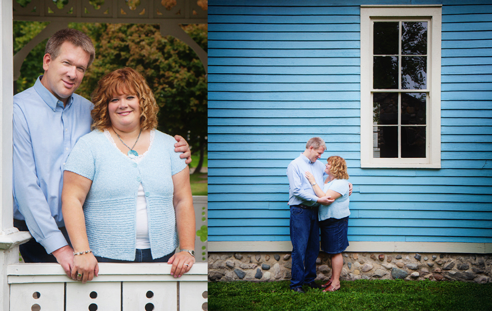 A man and woman pose together outdoors; on the left, they stand by a white wooden railing, smiling, while on the right, they embrace in front of a blue wooden building with a window—captured by a wedding engagement portraits photographer.