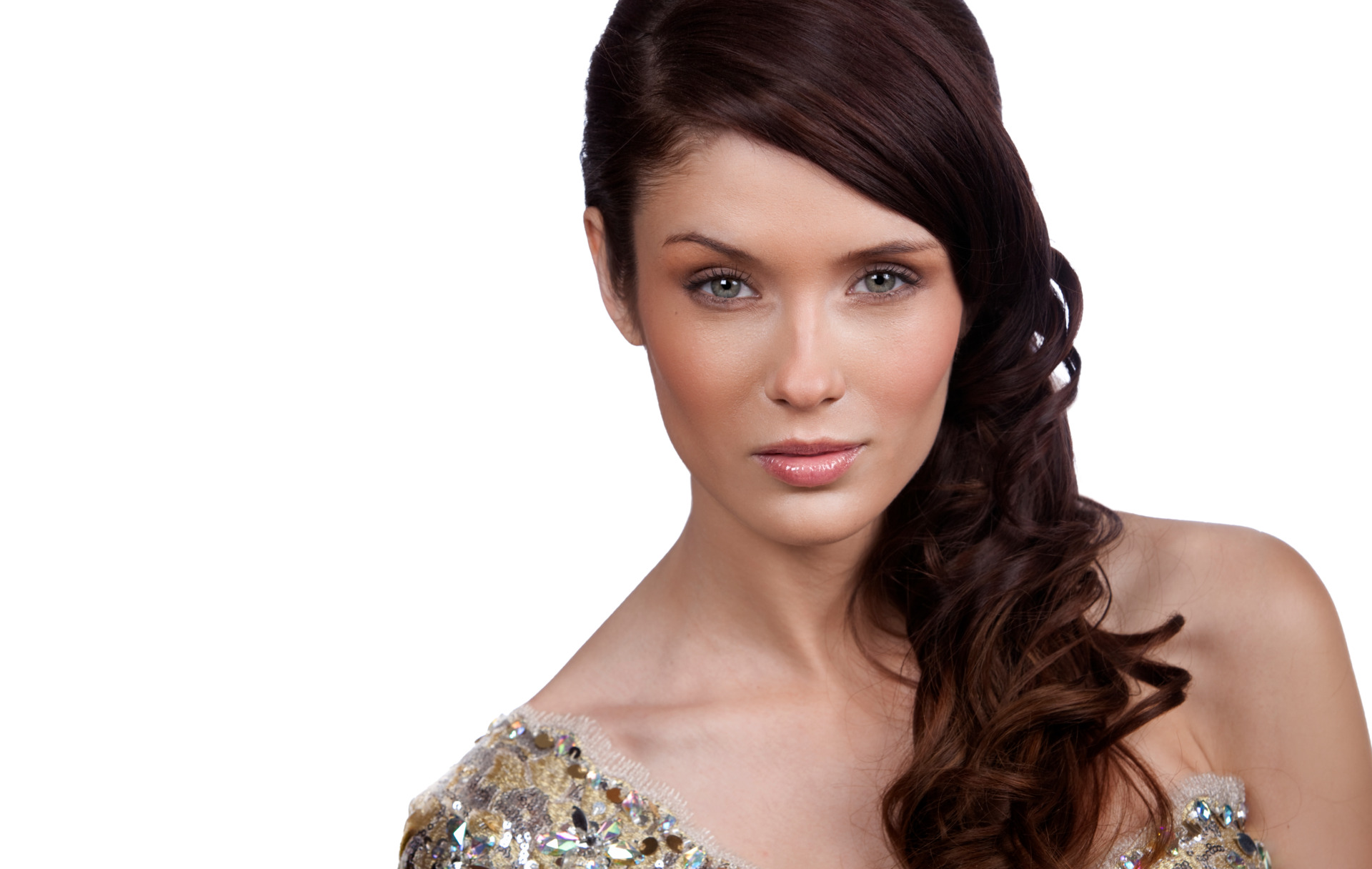 A woman in a gold dress posing for a professional pageant headshot against a white background