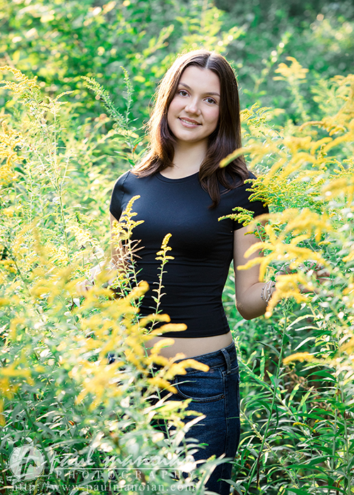 Outdoor senior pictures among wildflowers and greenery