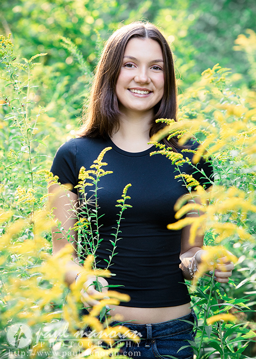 Flower field senior portrait with yellow wildflowers