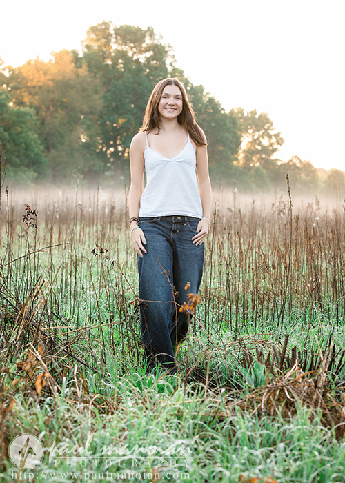 Senior pictures in a tall grass field in Michigan