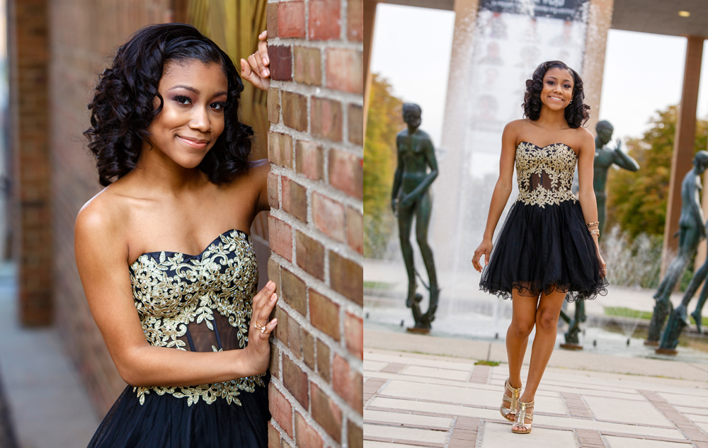 A young woman with curled hair wears a black and gold strapless dress, posing against a brick wall and walking confidently near statues and a fountain outdoors.