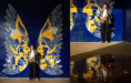 A person with short curly hair stands in front of a blue and yellow mural of large wings, holding a saxophone. The right image shows their reflection in a puddle beneath the mural.