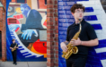 A young man holding a saxophone stands against a colorful mural of a jazz musician playing piano; he looks to the side and wears a black shirt and glasses.