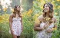 A high school seniori girl n a floral dress stands in a field of yellow flowers, captured elegantly for senior photographers.