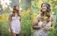 A high school seniori girl n a floral dress stands in a field of yellow flowers, captured elegantly for senior photographers.