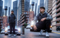 Two photos of a young man in a gray hoodie, black vest, and sneakers posing confidently in front of a white sports car on a city street, with tall buildings in the background.